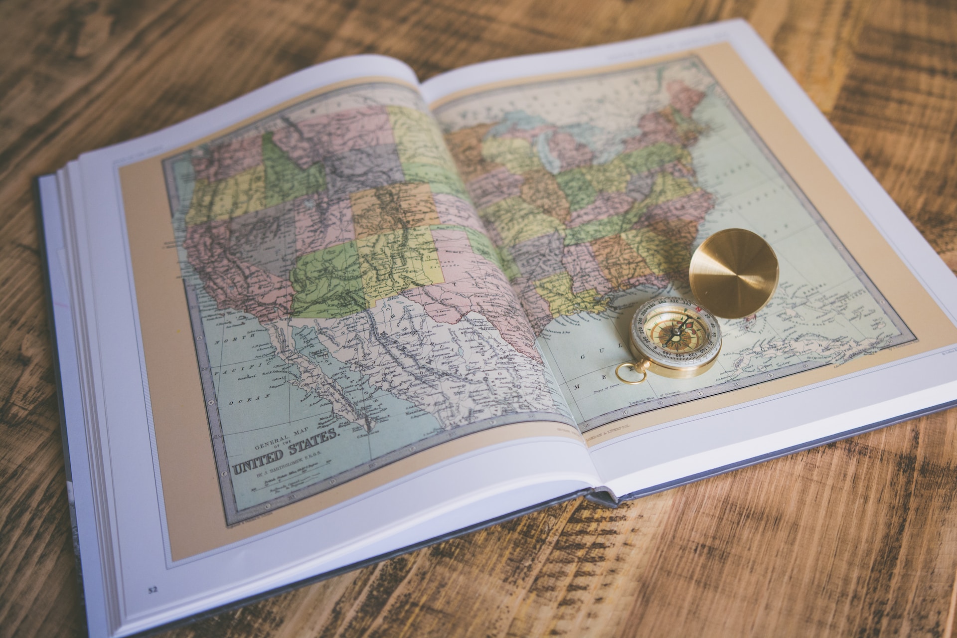 a map book with a compass
