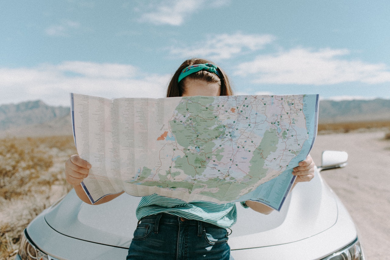 A lady studying a physical map.