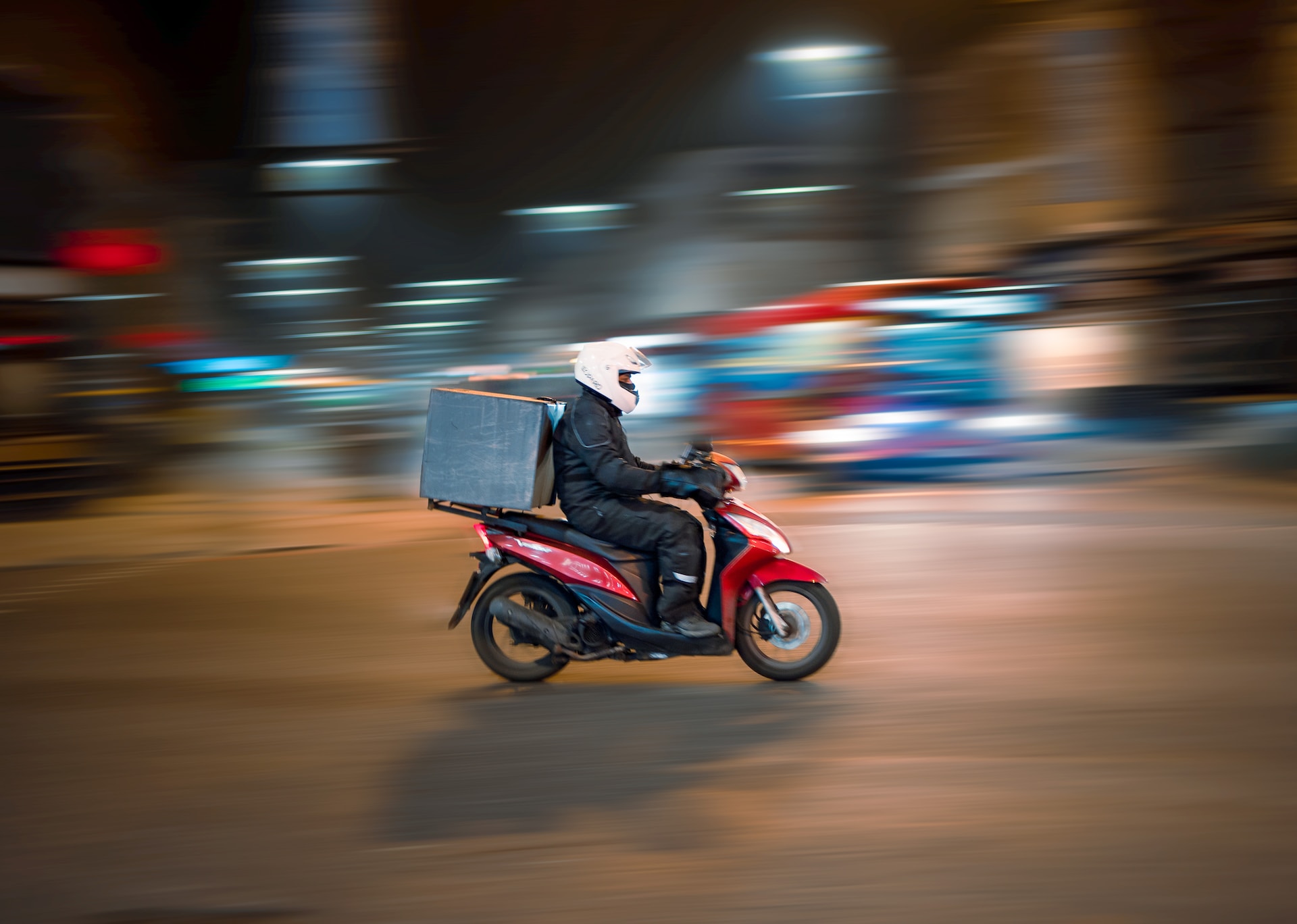 A delivery man riding a bike to deliver goods to customers.