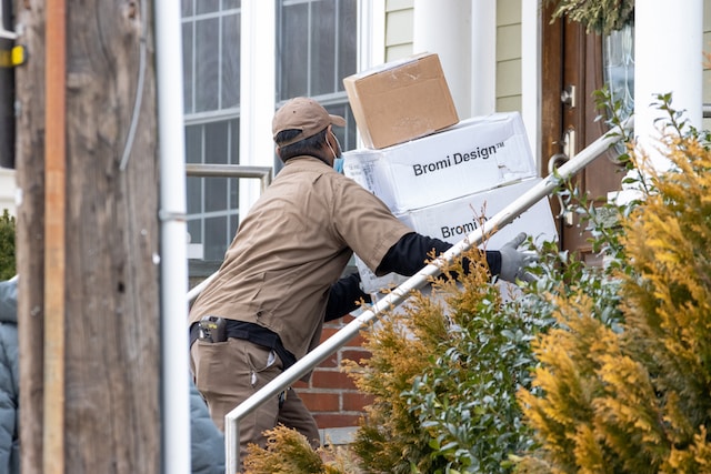 A delivery man delivering packages to a customer's doorstep.