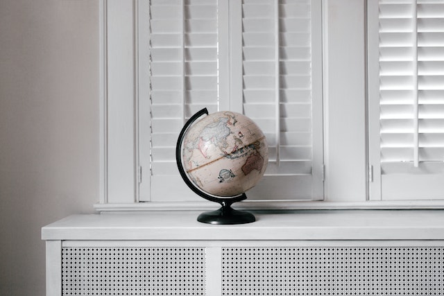 A white and black desk globe on a white table.