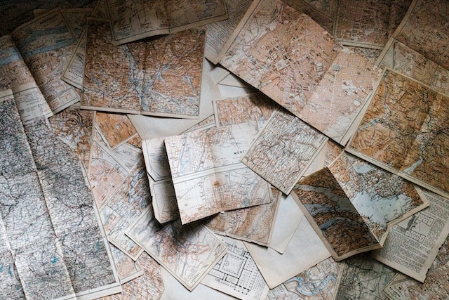 Different maps lying on a flat surface