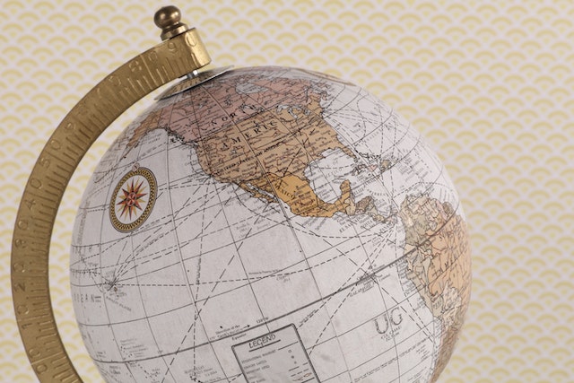 Close-up image of a globe with a gold stand.
