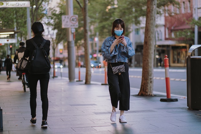 A lady checking her walking route along the neighborhood.