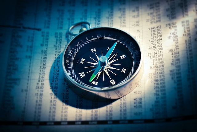 A compass placed on a sheet of data sets.