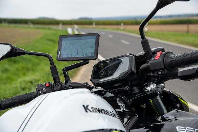 A motorcyclist checking a route via Google Maps on his bike.
