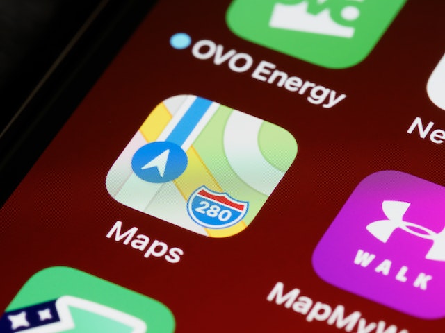 A close-up view of the Apple Maps icon on a mobile phone’s home screen.