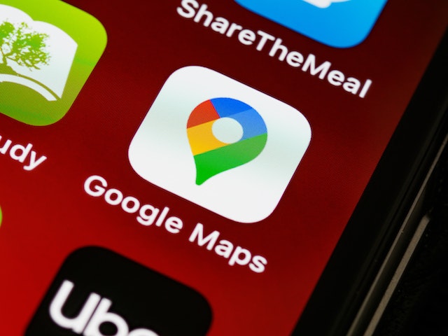 A close-up image of a smartphone's Google Maps icon and other mobile app icons