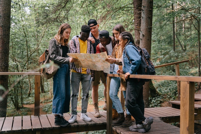 A group of travelers checking routes leading to their destination.