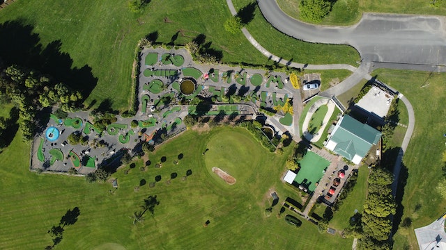 An aerial view of a green grass field