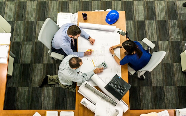 A delivery team of two men and a lady working round the clock and sorting important data for their organization.