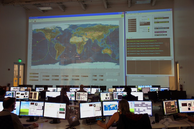 A team at the space program center utilizing a thematic map in its operations.