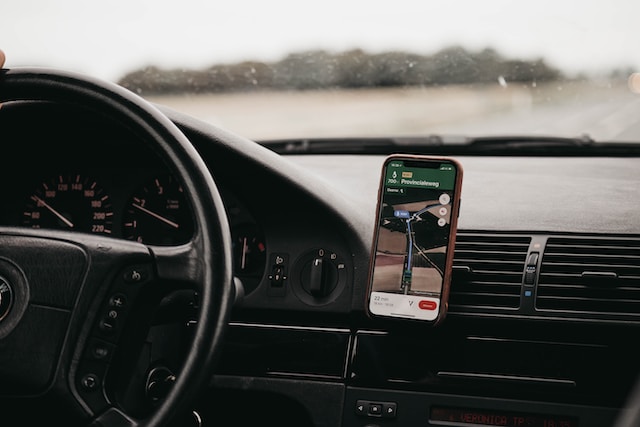 A smartphone’s Google Maps in use in a car during a road trip.