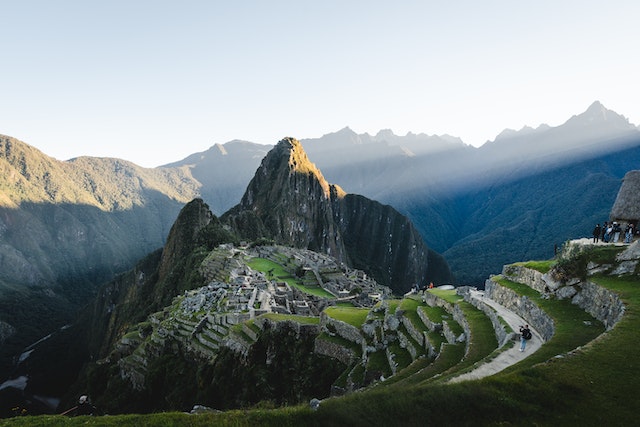 Wide view of the stone buildings and mountains of Machu Picchu in Peru.