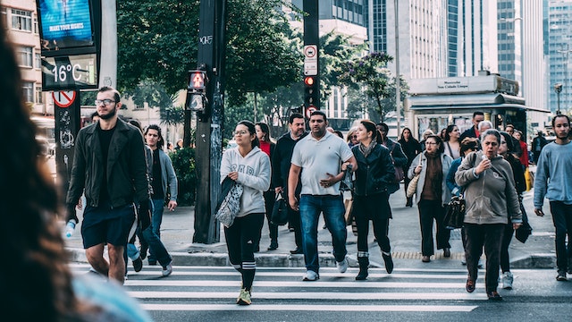 A group of pedestrians commuting in an urban landscape. 