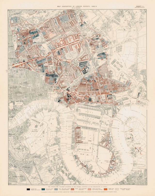 A government official uses a thematic map to locate low-income households in London, U.K.