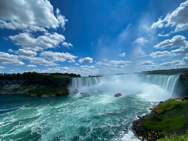 Tourists take a boat to go close to Niagara Falls, a popular destination in Canada.